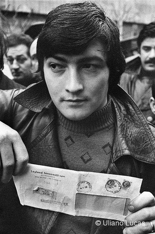A worker displays a letter of dismissal of Leyland Innocenti during a demonstration outside the headquarters of RAI, Milan, 1976