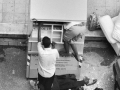 Searching for clothes in a dumpster of old clothes, Bari, 2008