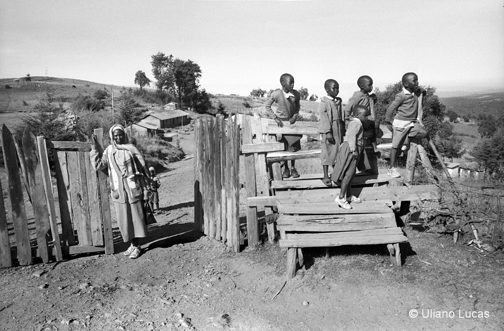 Studenti di una pluriclasse guardano gli allenamenti dei maratoneti lungo la strada che porta a Kapsabet, Kenya, 2014