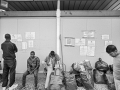 In attesa della distribuzione del vestiario e degli oggetti per la pulizia personale nel Centro Fenoglio, Settimo, maggio 2017